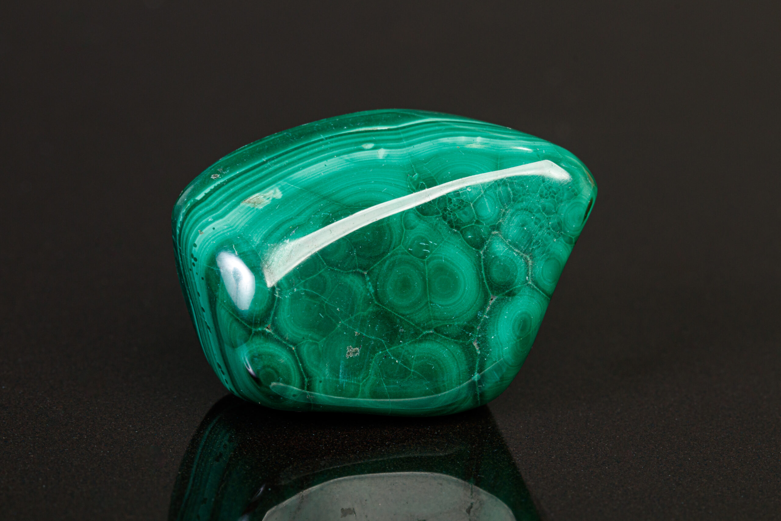 macro mineral stone malachite on a black background close-up